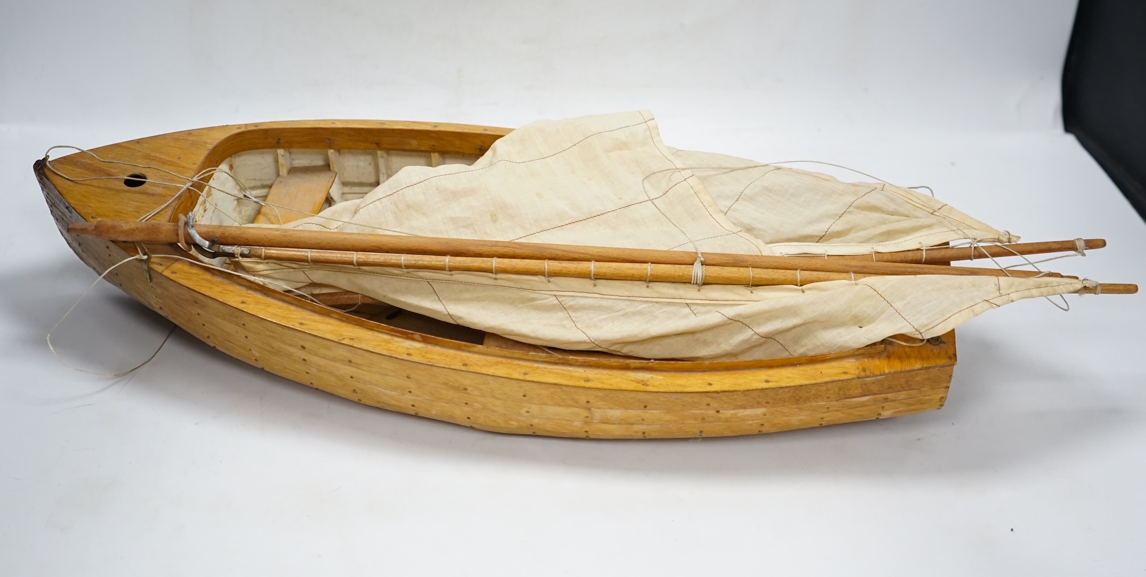 A mid 20th century kit built wooden model sailing boat, ‘Rob’, of plank on frame construction with white painted interior, hull 45cm long. Condition - fair to good.